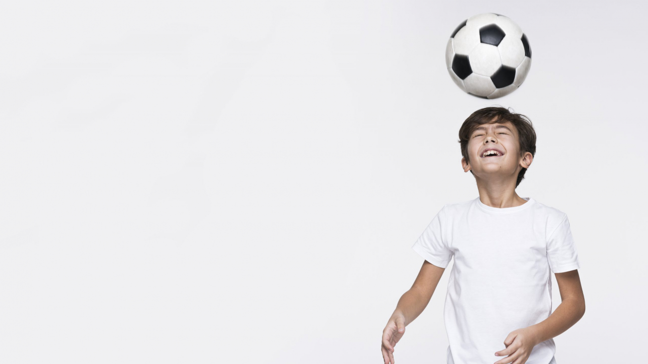 young-boy-playing-with-football-ball