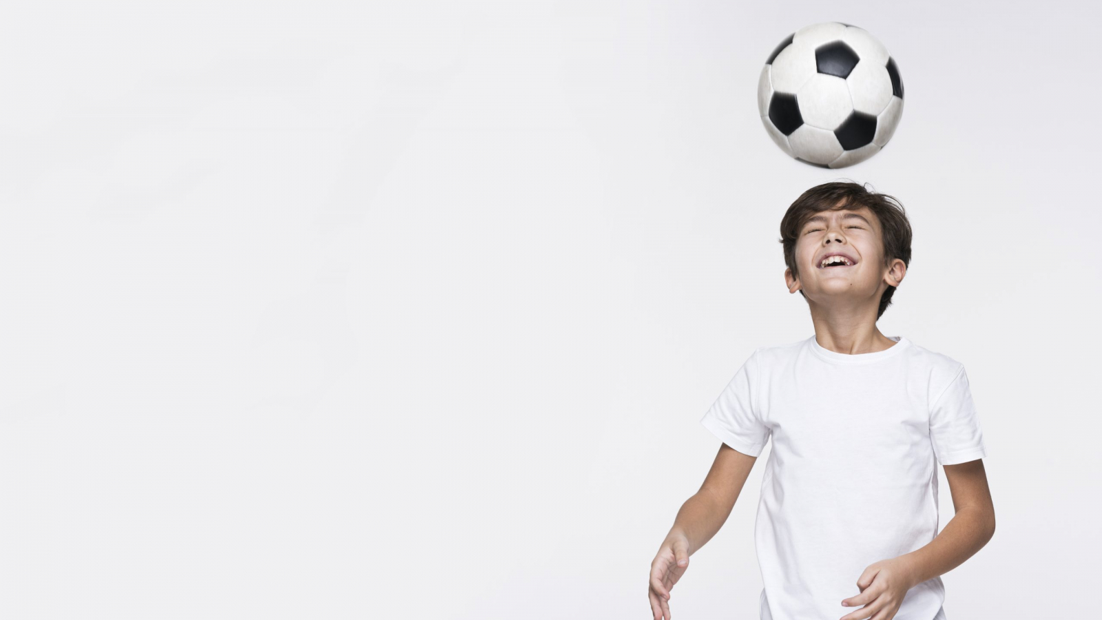 young-boy-playing-with-football-ball